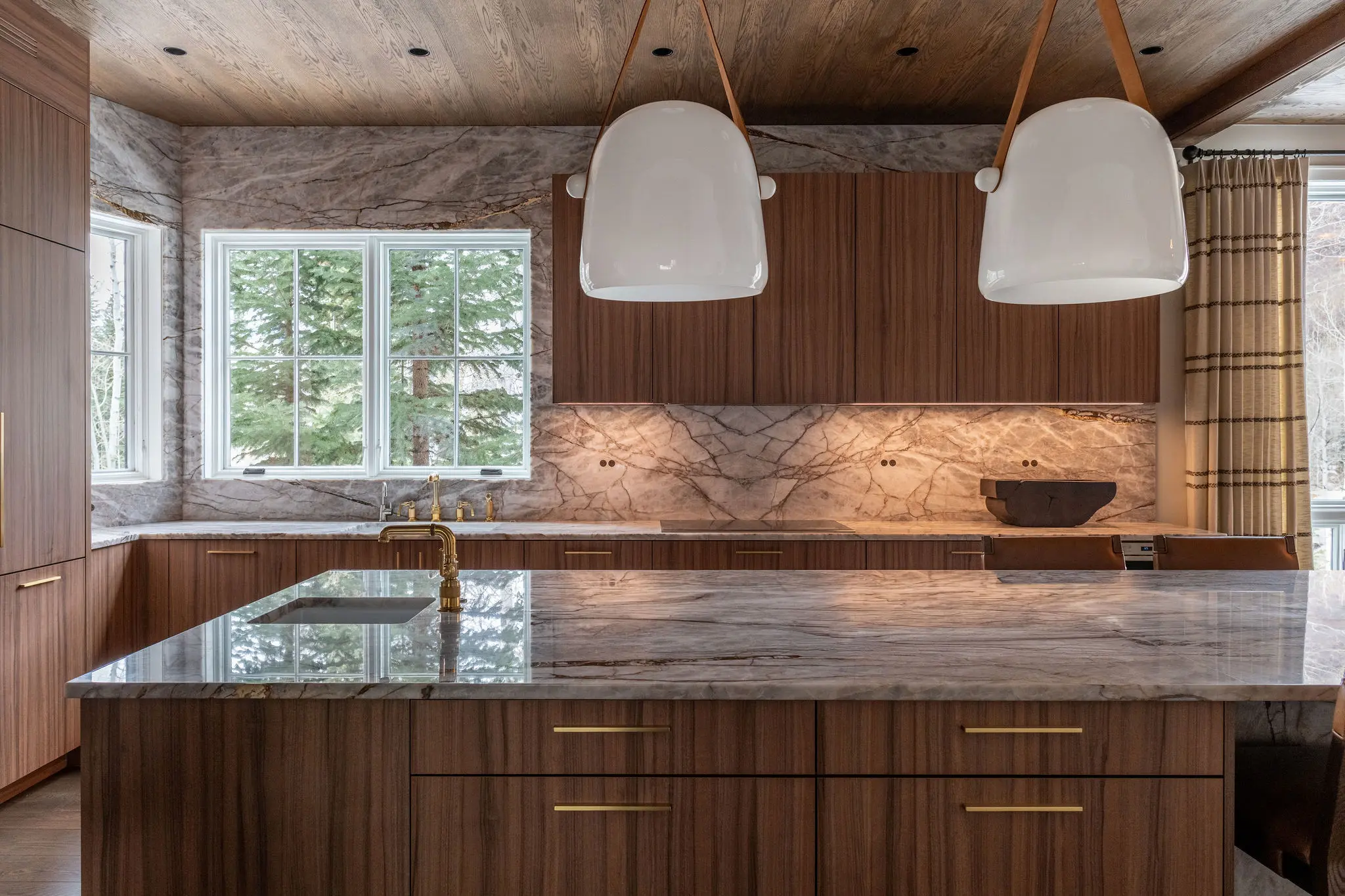 Modern kitchen with marble island and pendant lights
