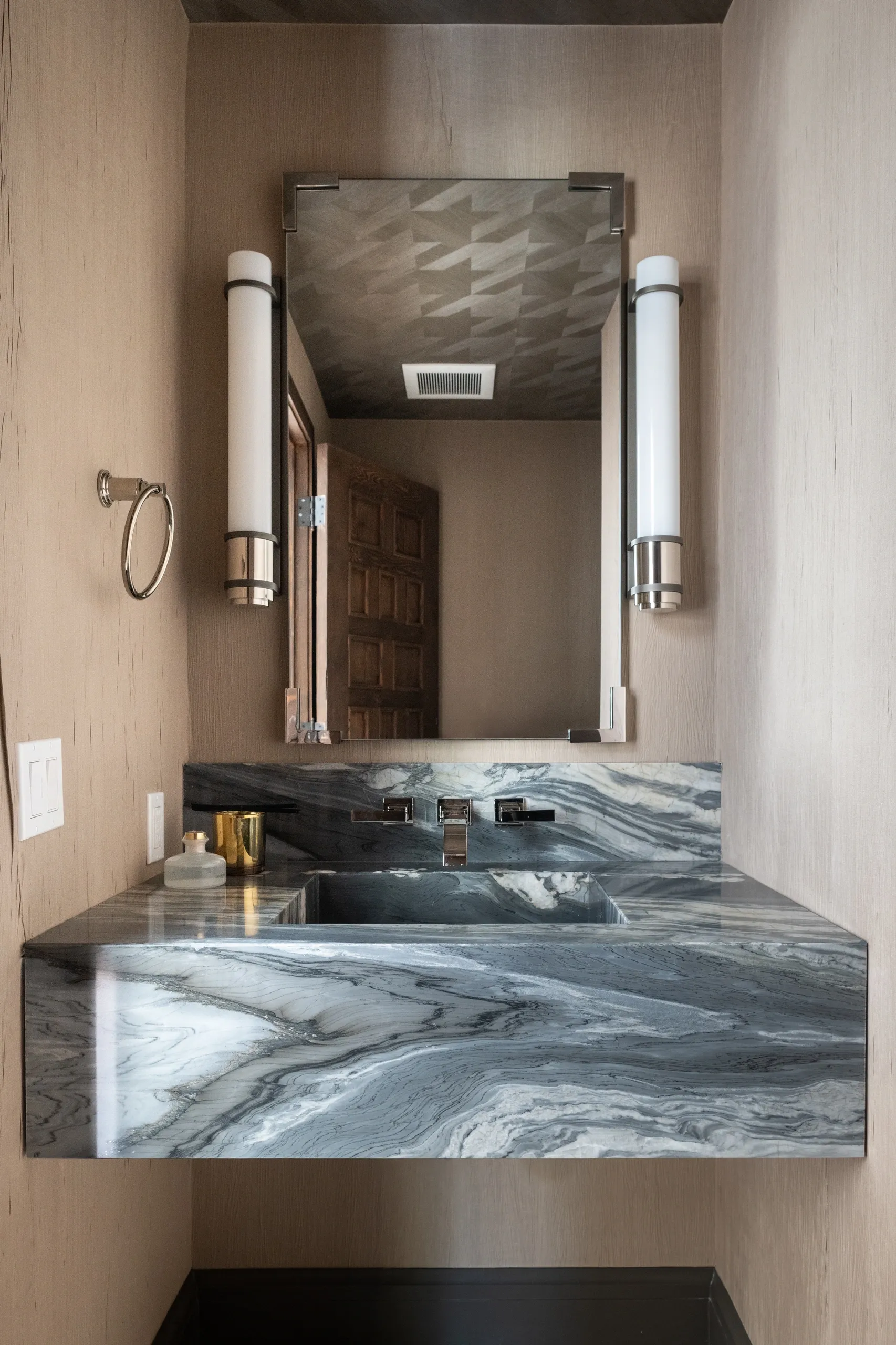 Floating marble sink with mirror and sconces